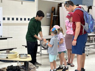 A portable pottery wheel station set up at a school event